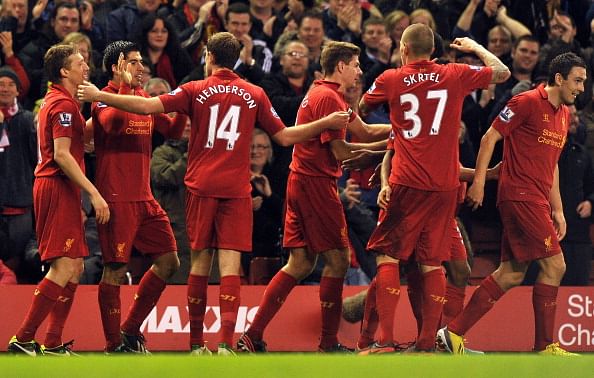 Liverpool's Uruguayan striker Luis Suarez (2nd L) celebrates scoring their third goal with teammates during the English Premier League football match between Liverpool and Sunderland at Anfield in Liverpool, north-west England on January 2, 2013. Liverpool won the game 3-0. AFP PHOTO/PAUL ELLISRESTRICTED TO EDITORIAL USE. No use with unauthorized audio, video, data, fixture lists, club/league logos or ?live? services. Online in-match use limited to 45 images, no video emulation. No use in betting, games or single club/league/player publications.